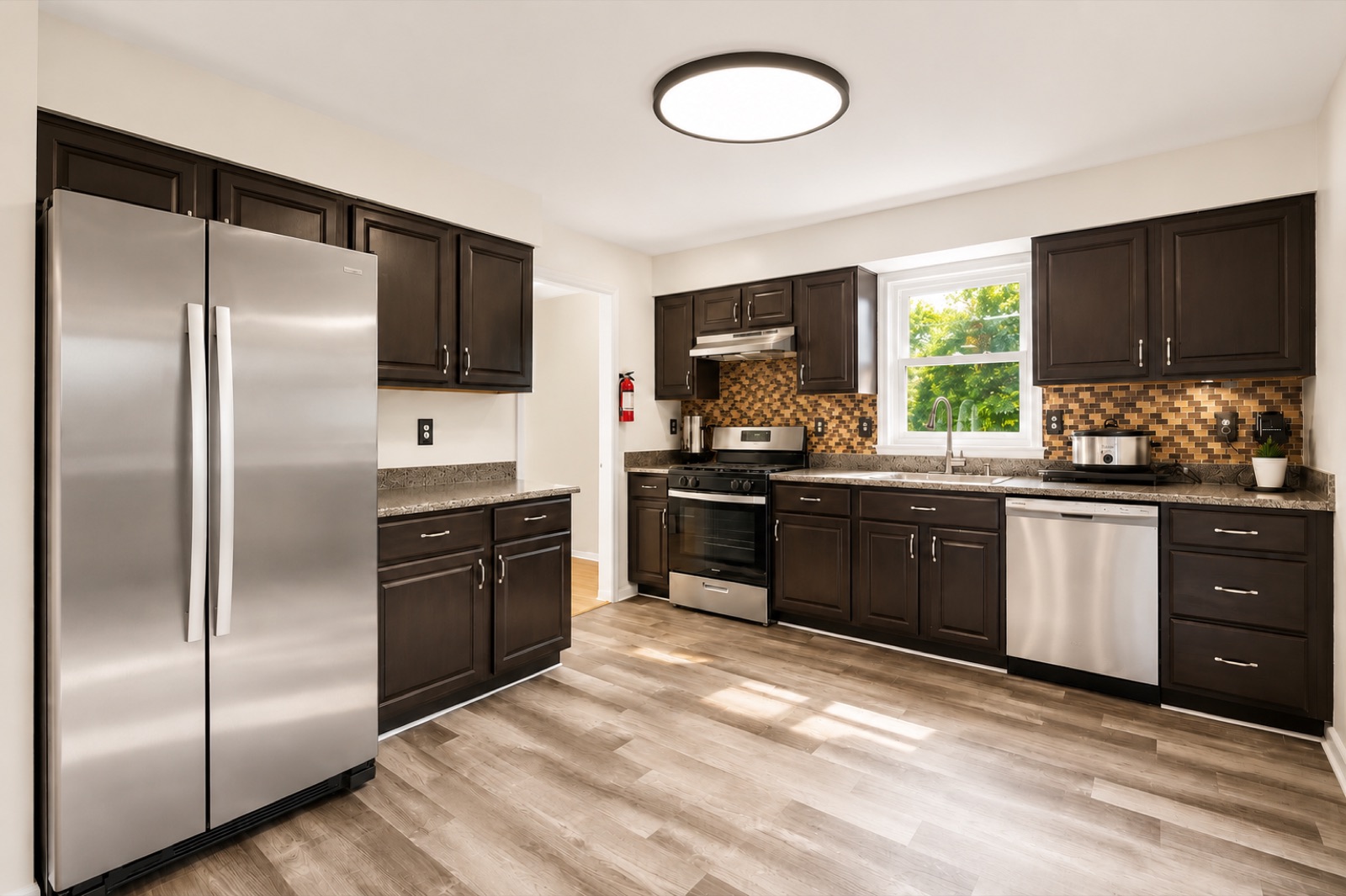 Chef's kitchen with espresso cabinetry and stainless appliances